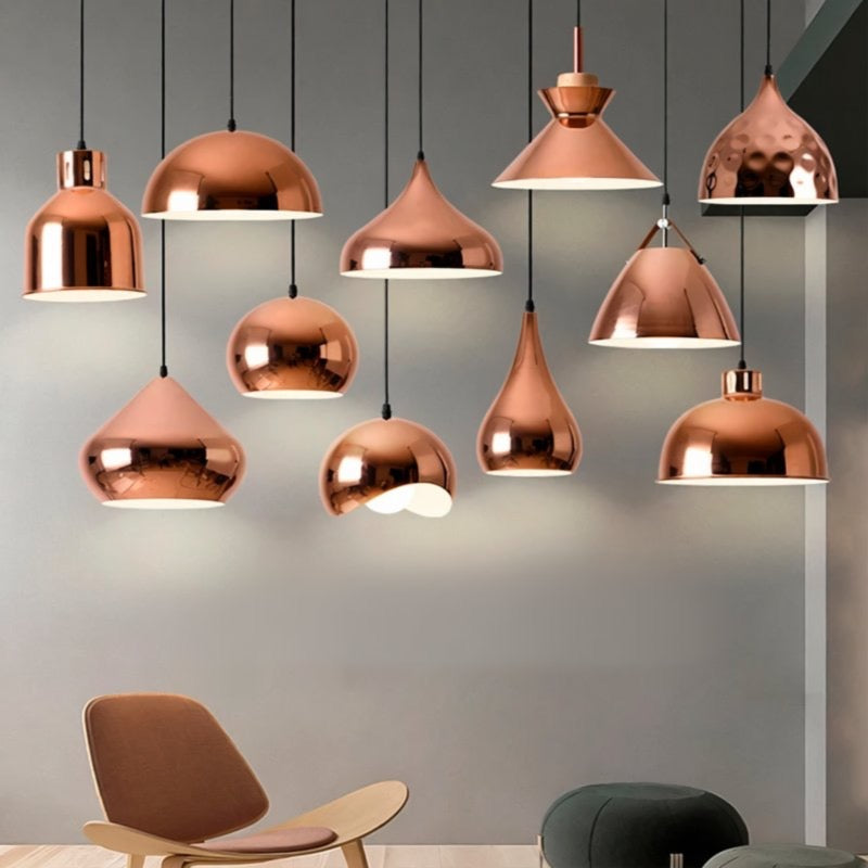 a collection of copper-colored pendant lights suspended from the ceiling, creating a warm and inviting atmosphere in the room.