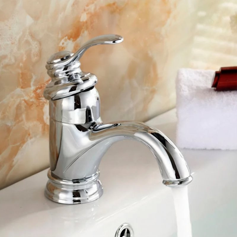 A chrome faucet with a curved handle is mounted on a white sink, with a towel and a red object visible in the background.